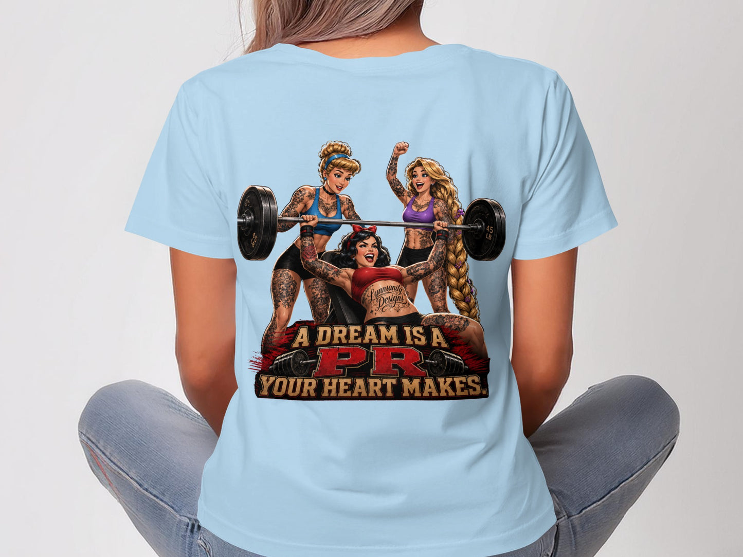 Three tattooed women lifting weights with text "A dream is a PR your heart makes."