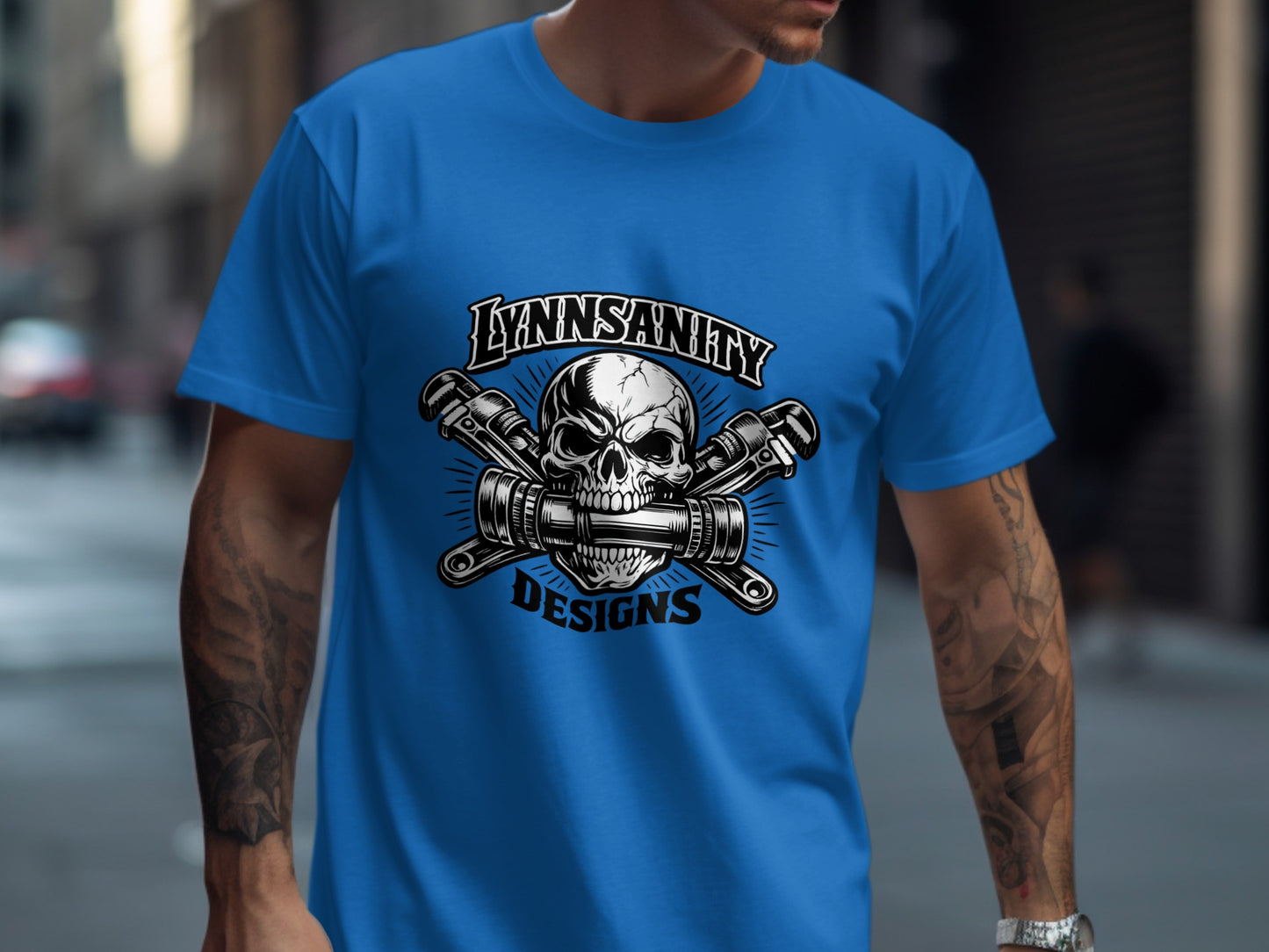 Blue t-shirt with skull and wrenches logo.