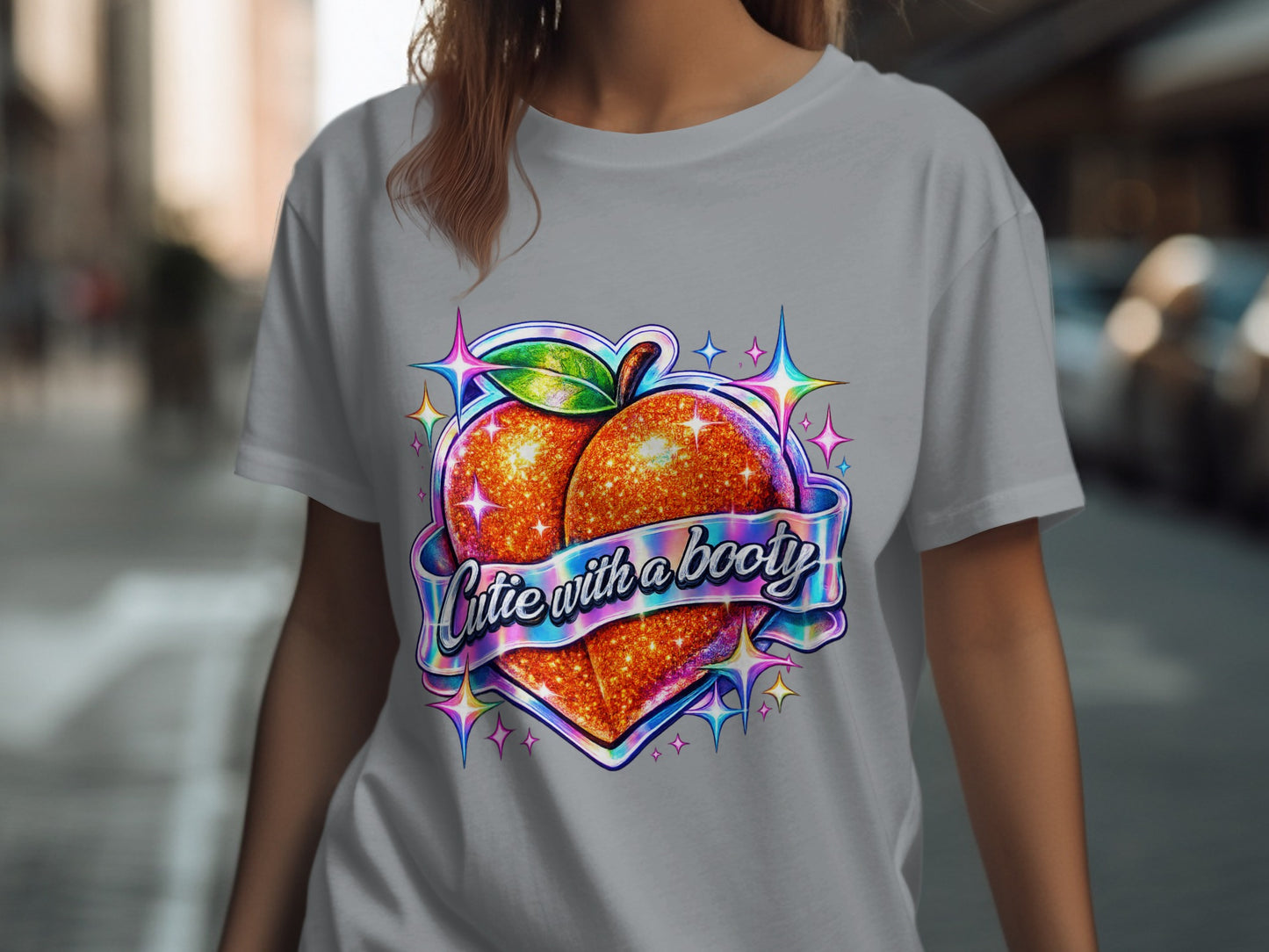 Glittering peach graphic with "Cutie with a booty" text on gray t-shirt.