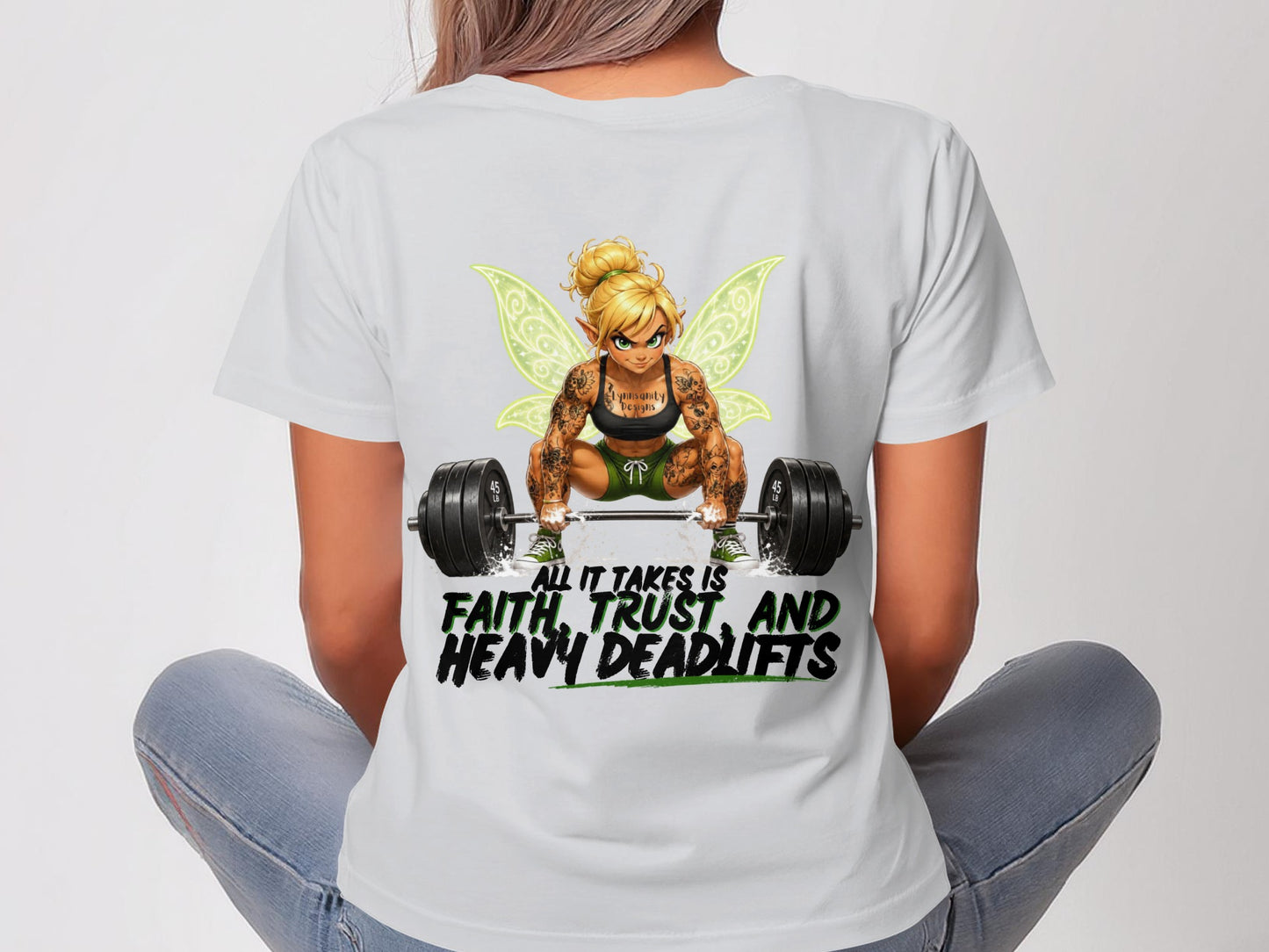 Woman wearing white t-shirt with fairy lifting weights graphic and text.
