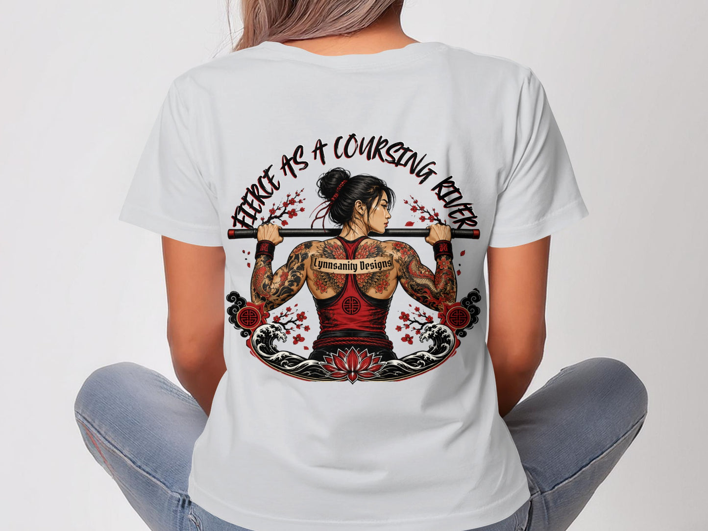 Woman in white t-shirt with back tattoo of dragon and text "fierce as a coursing river".