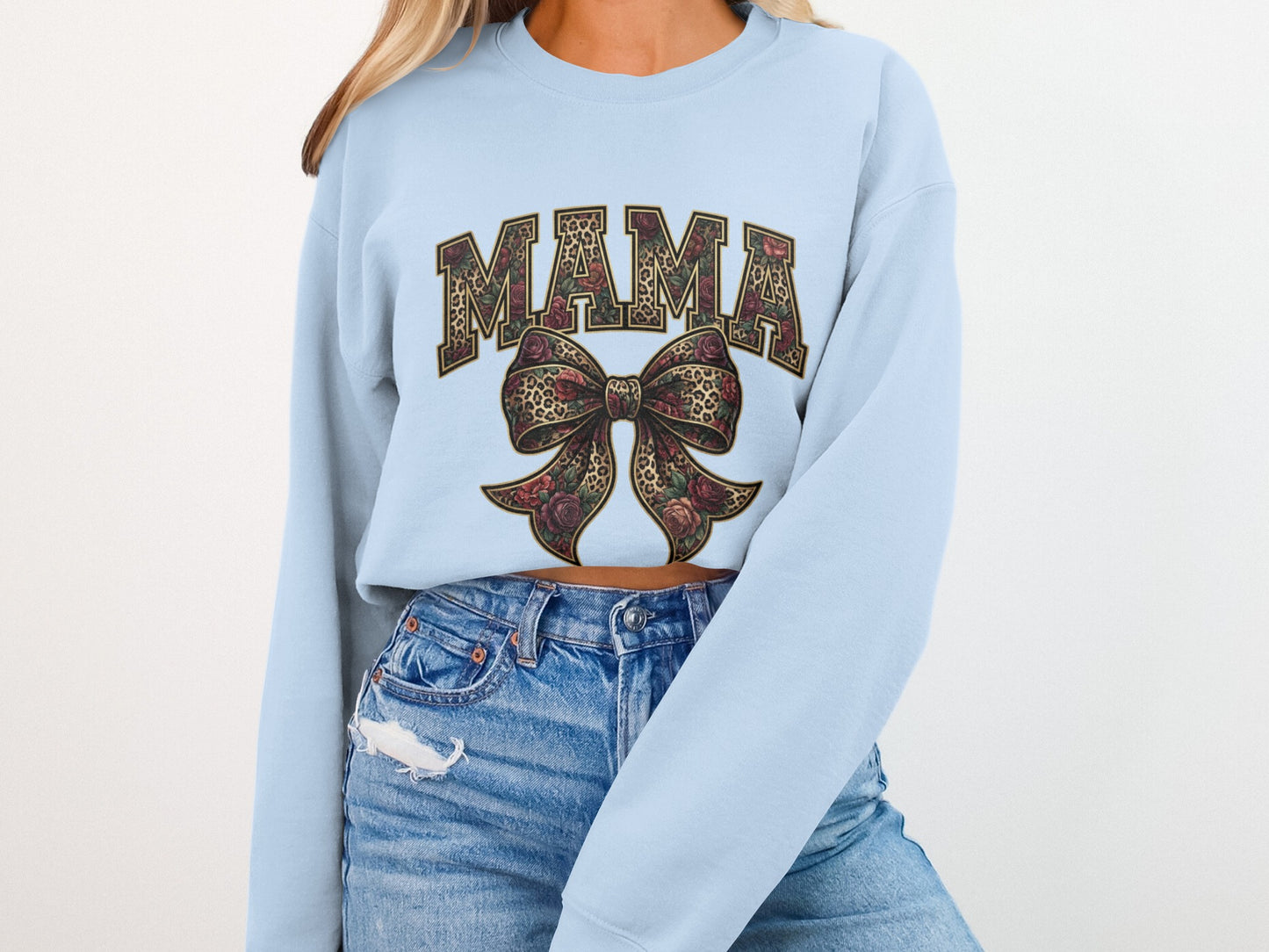 Light blue sweatshirt with "MAMA" in floral and leopard print, and a bow.