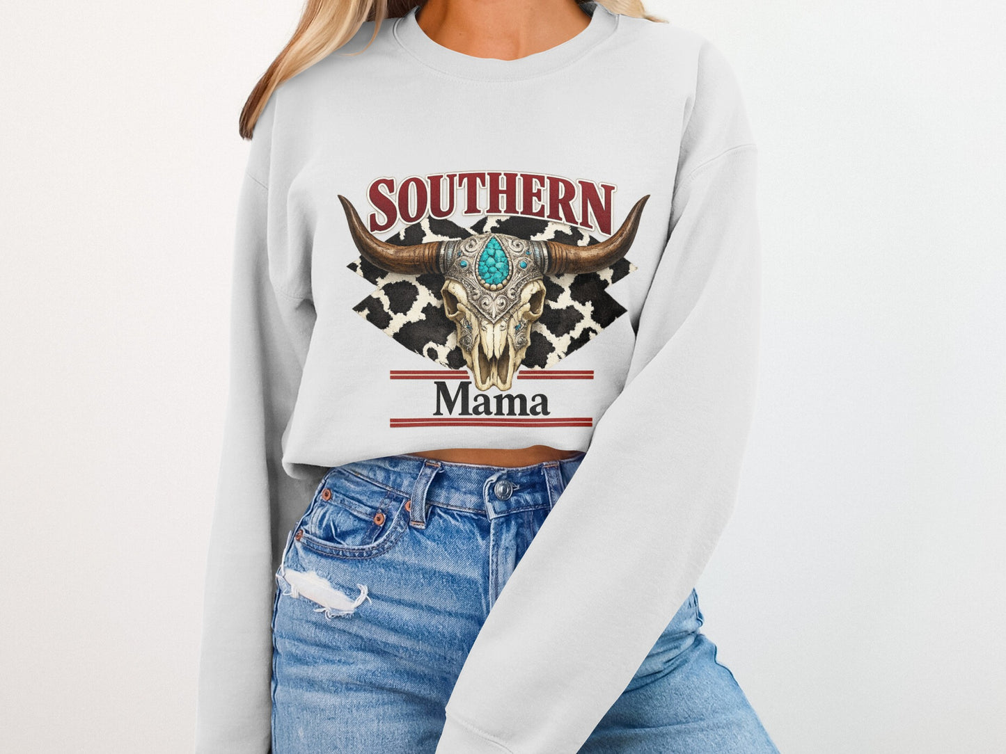 Cow skull with turquoise adornment and "Southern Mama" text on a sweatshirt.