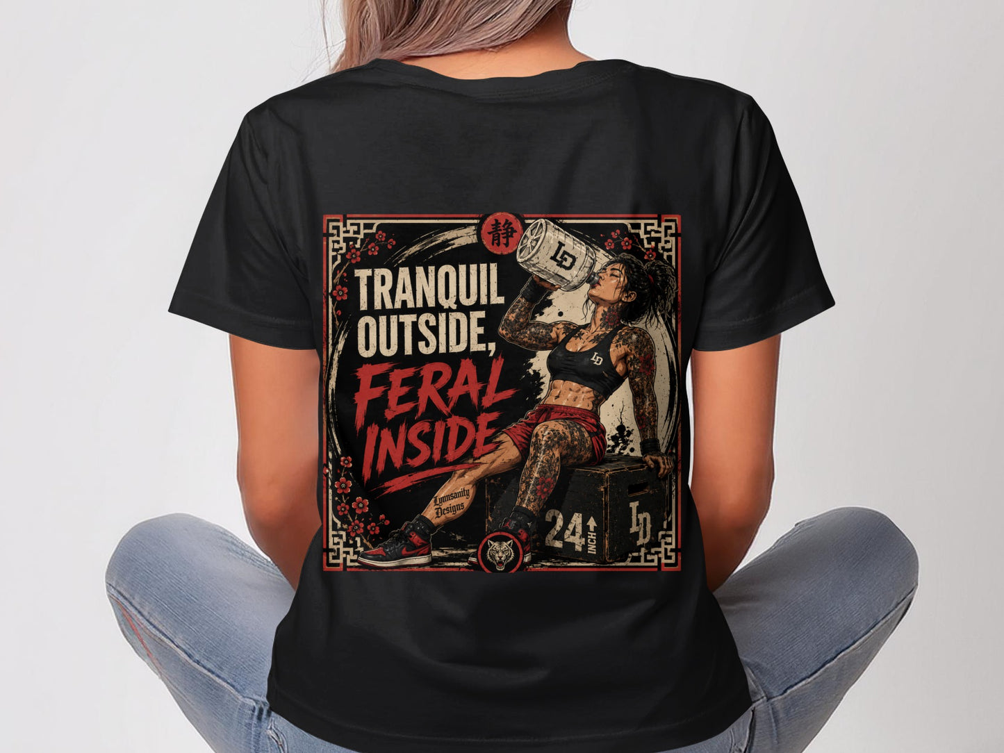 Woman in t-shirt with "Tranquil Outside, Feral Inside" graphic and Japanese-inspired frame.