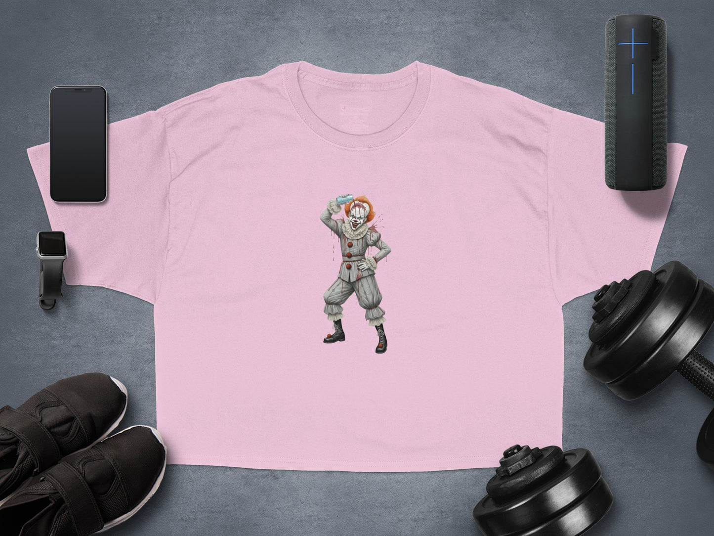 Pink t-shirt with a clown illustration holding a blue balloon.