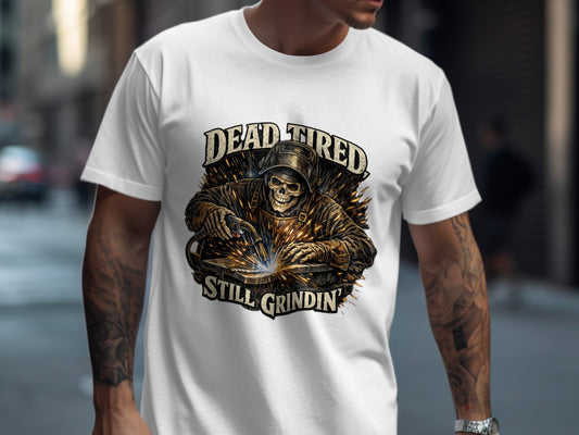 White t-shirt with skull welder graphic and "Dead Tired Still Grindin" text.