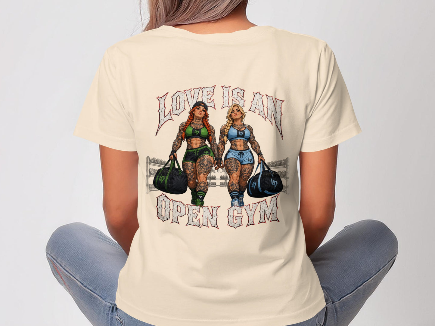 Two tattooed women with gym bags walk forward, text reads "LOVE IS AN OPEN GYM".