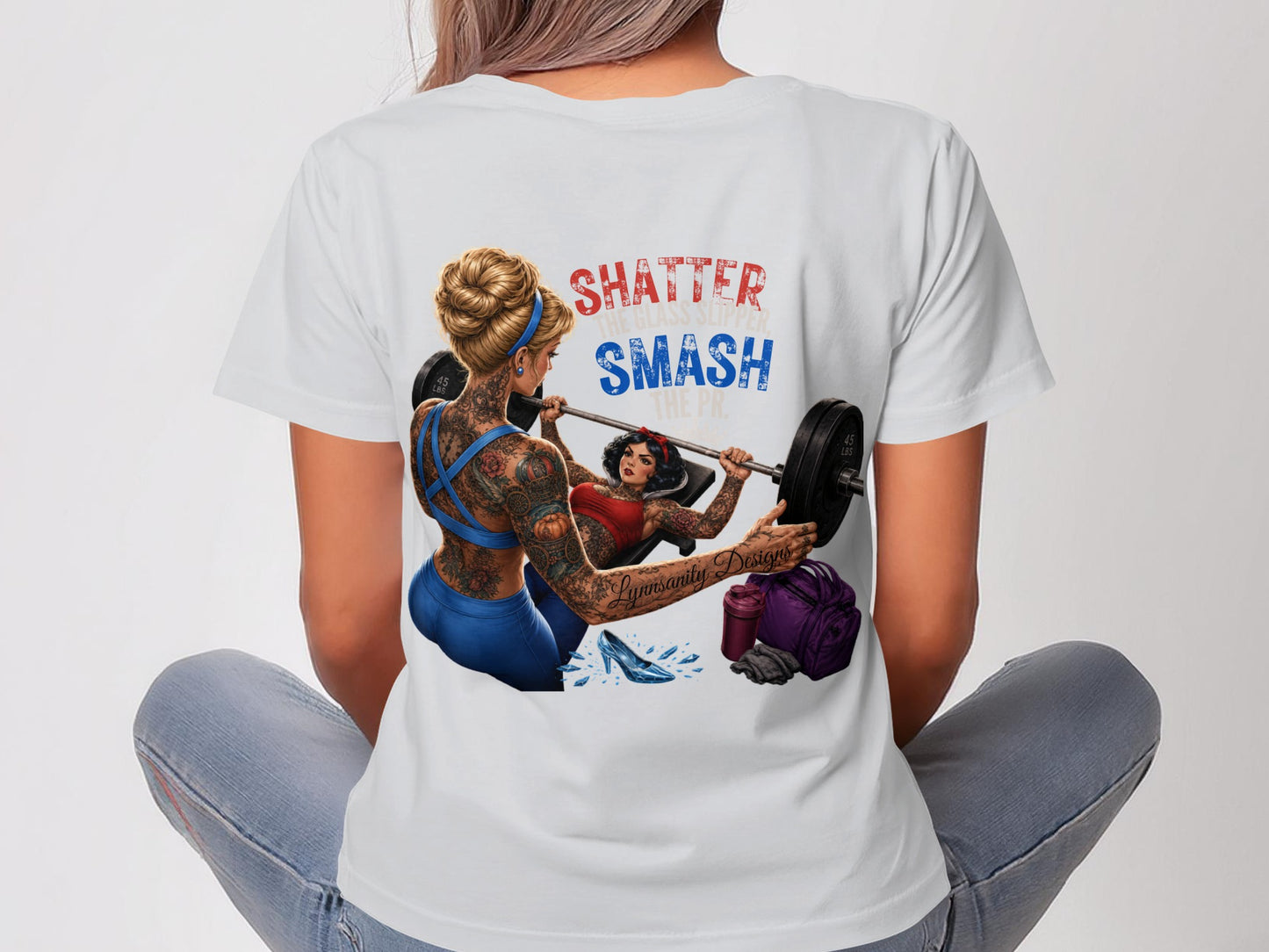 Woman in t-shirt with barbell and inspirational text "SHATTER SMASH".