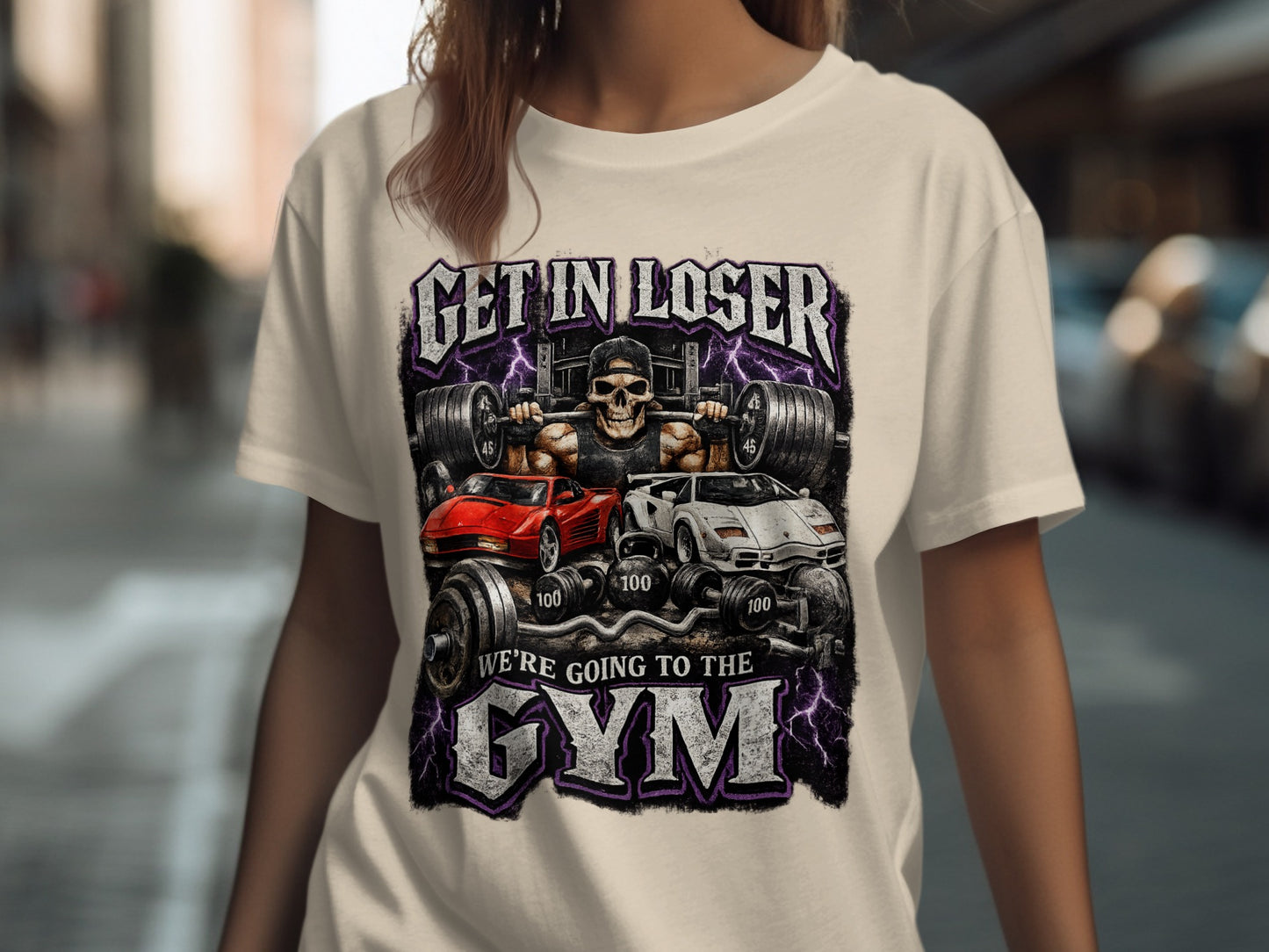 T-shirt with graphic of skull, weights, and sports cars with text "GET IN LOSER WE'RE GOING TO THE GYM".
