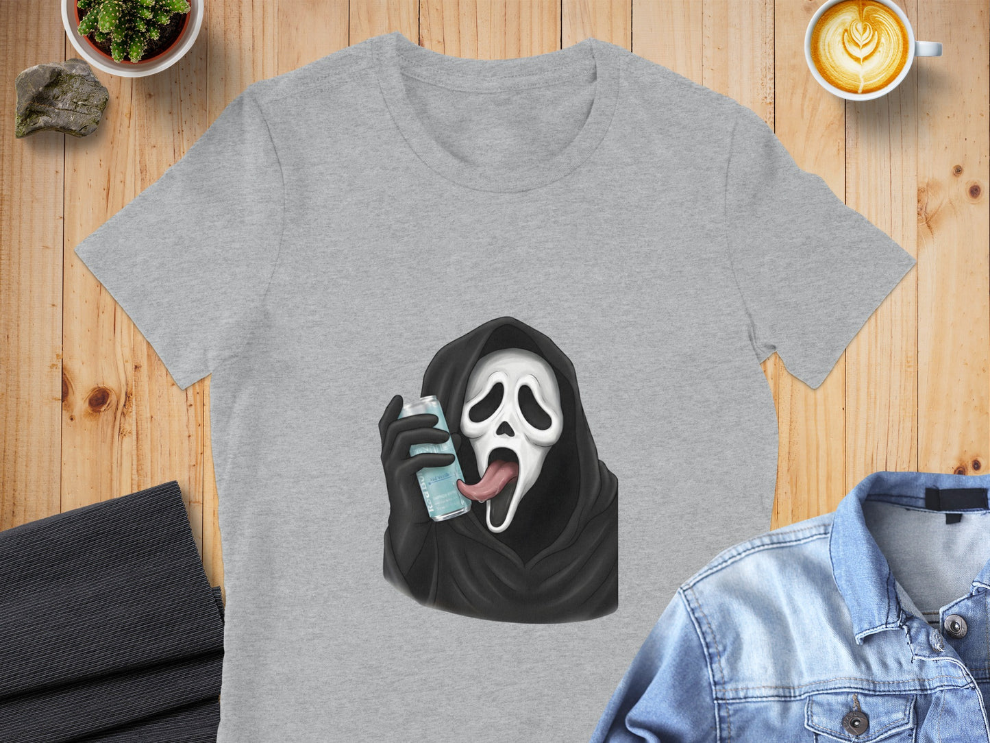 Grey t-shirt with cartoon Ghostface from Scream holding a blue can.