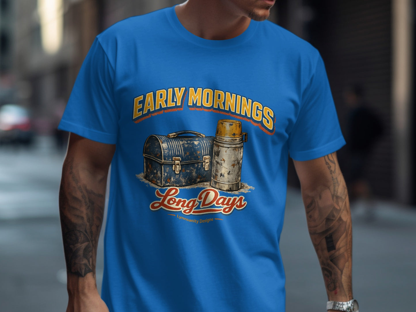 Blue t-shirt with vintage lunchbox and thermos graphic and "Early Mornings Long Days" text.