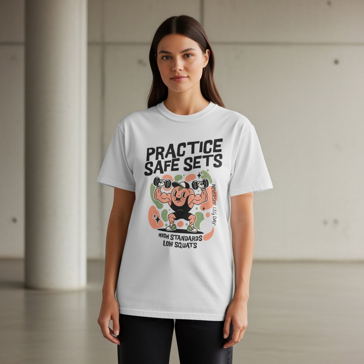 White t-shirt with graphic of muscular figure and text "Practice Safe Sets".