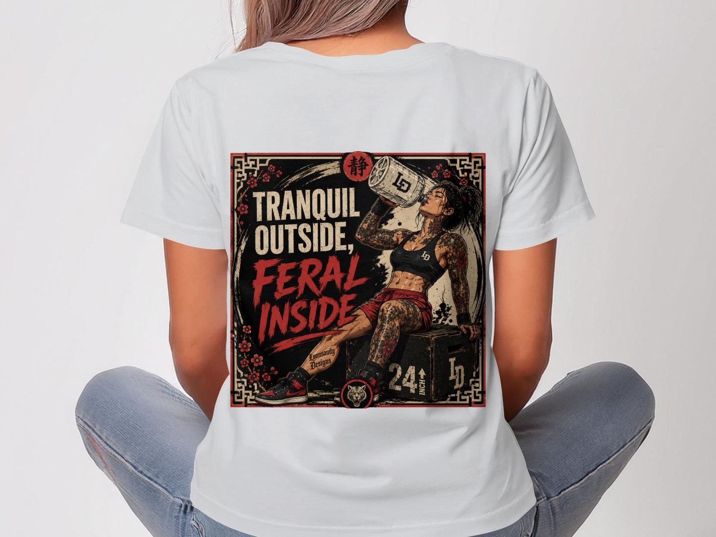 Woman wearing t-shirt with "Tranquil Outside, Feral Inside" text and graphic.