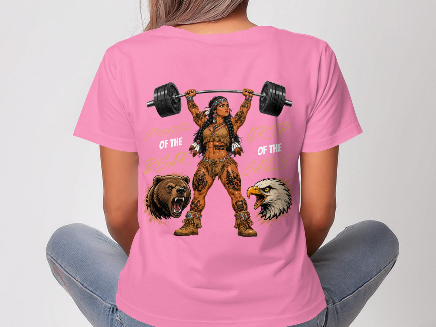 Woman in pink shirt lifts barbell, Native American-inspired graphics.