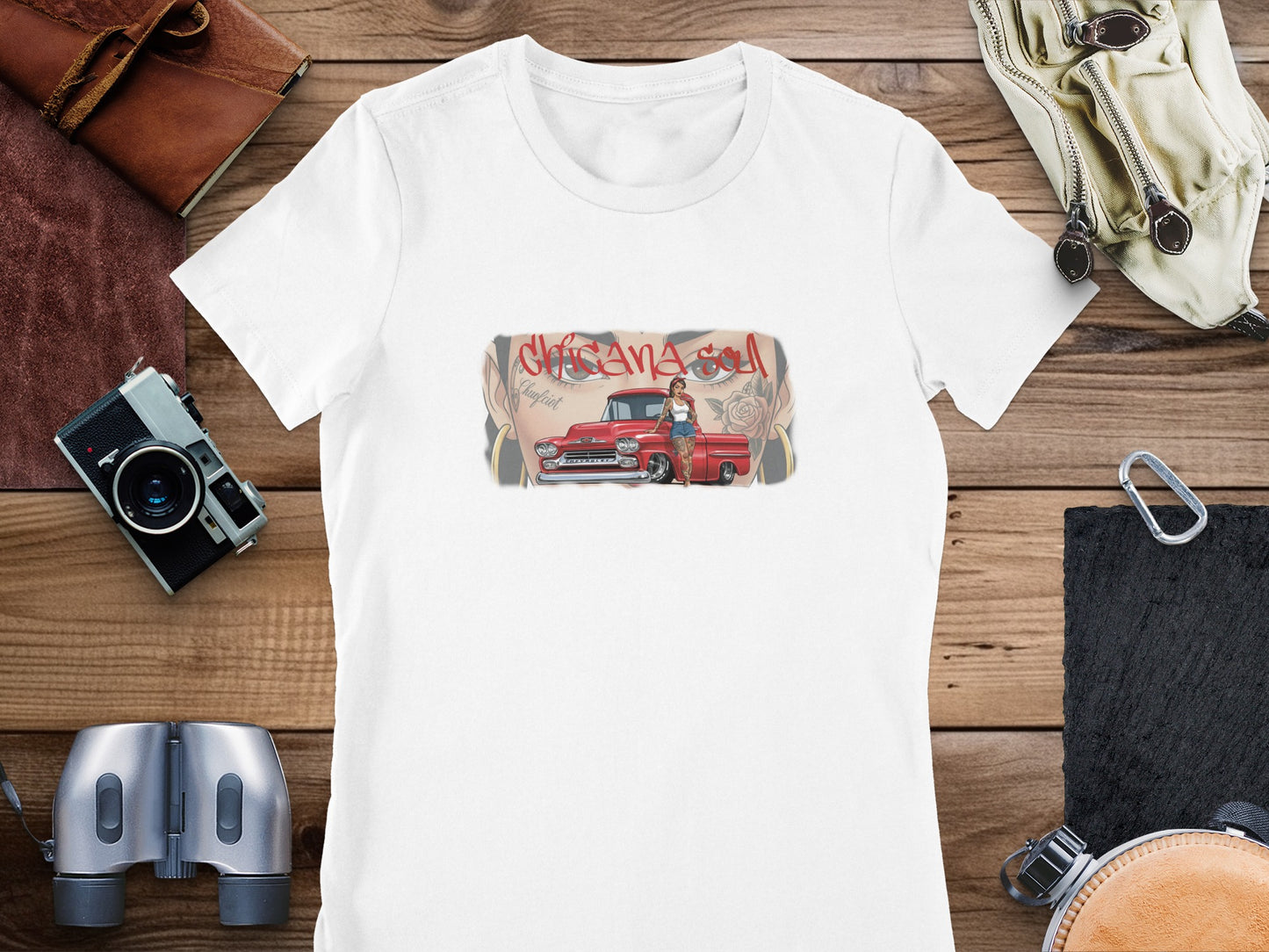 Woman with red car graphic on a white t-shirt, surrounded by accessories.