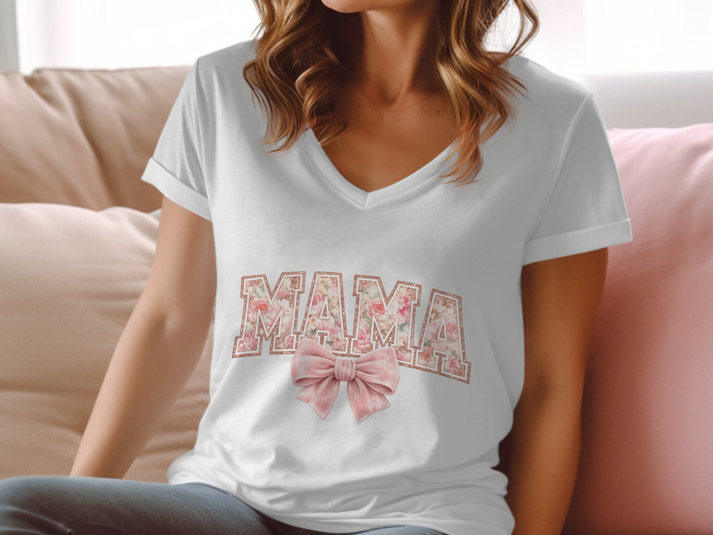 White v-neck t-shirt with "Mama" in floral print and a pink bow.