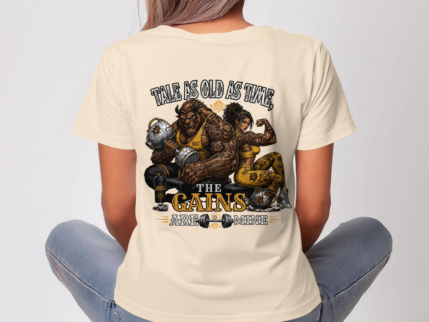 Tale as old as time, the gains are mine graphic on a light tan t-shirt.