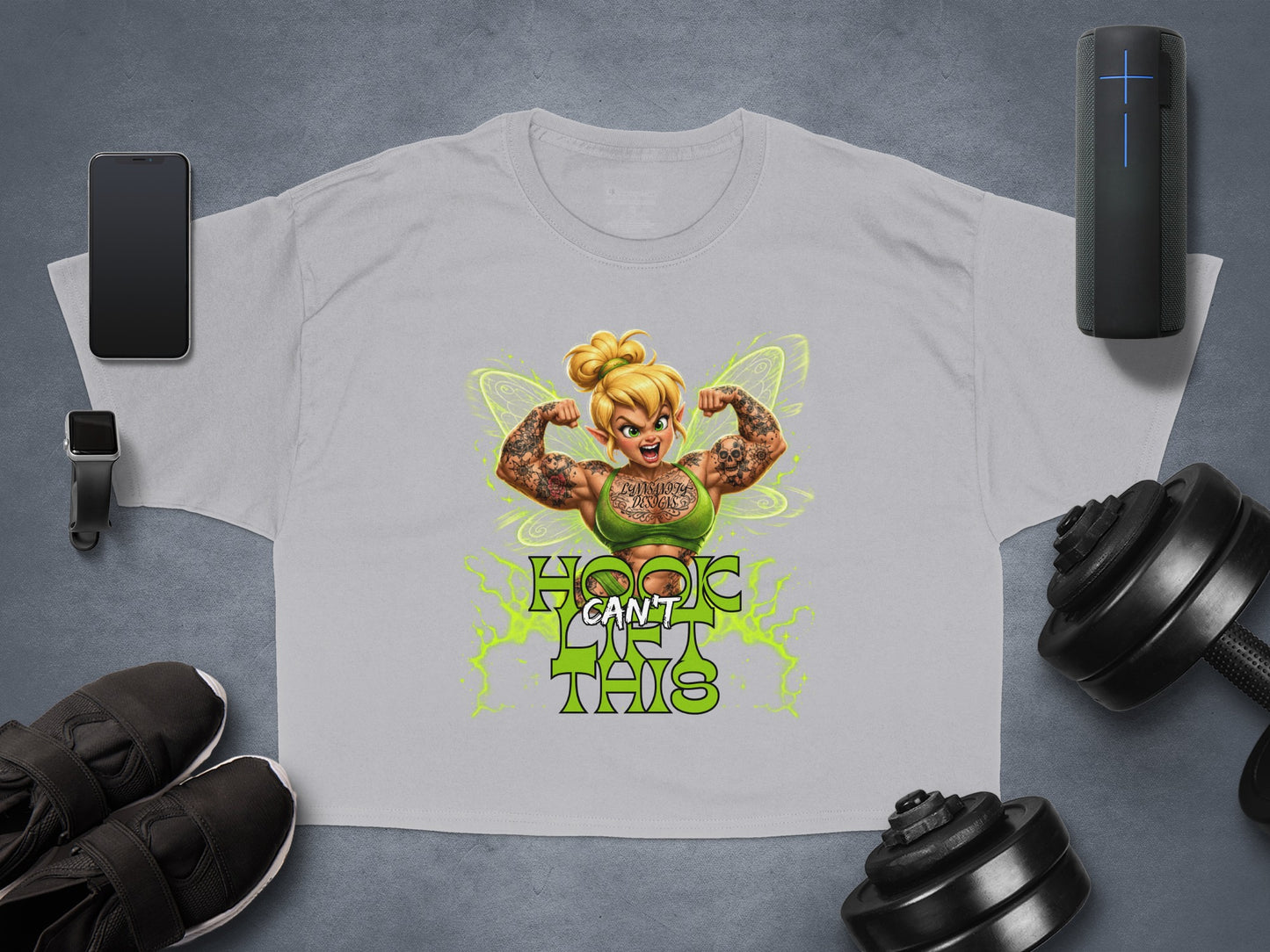 Tinkerbell with tattoos flexing on a grey t-shirt with text.