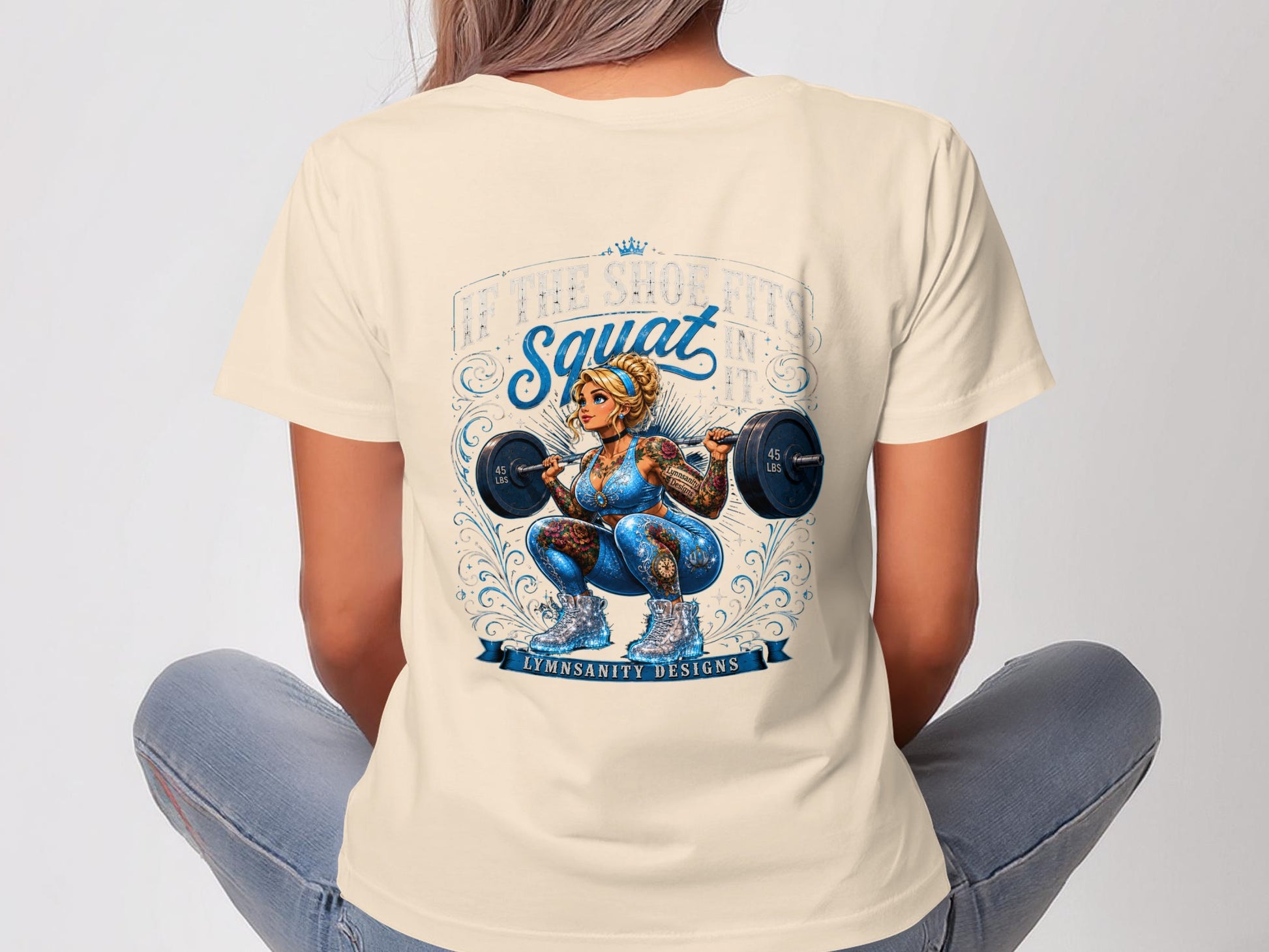 Woman in blue workout gear with tattoos lifting a barbell, "LET THE SQUAT SINS IN" text.