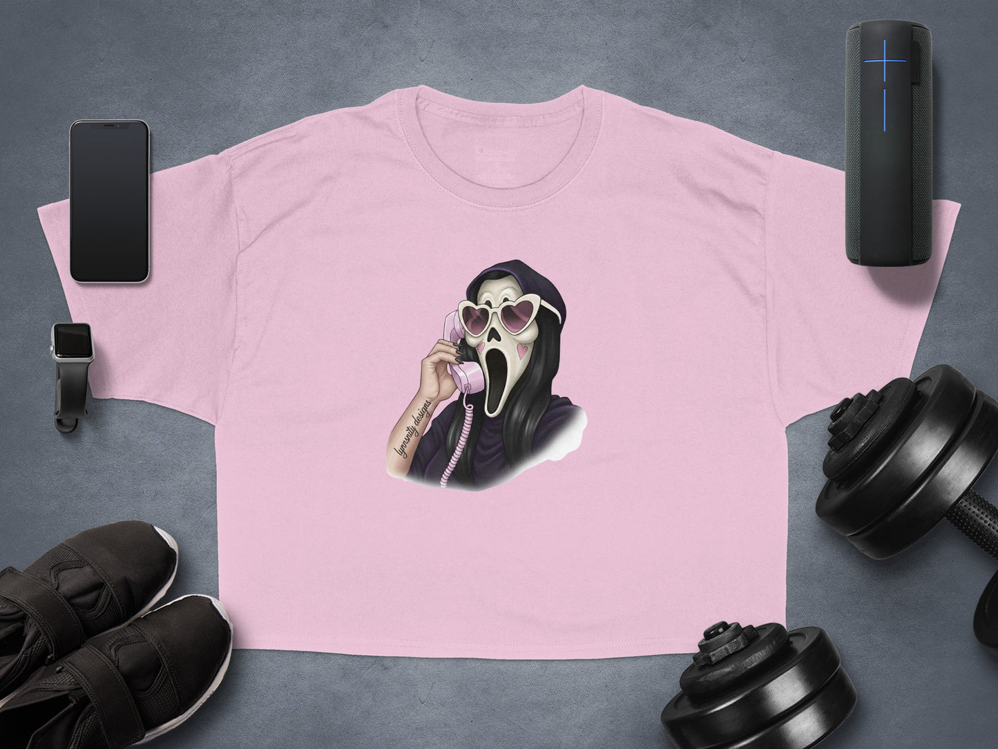 Pink t-shirt with graphic of Ghostface on phone wearing heart sunglasses.