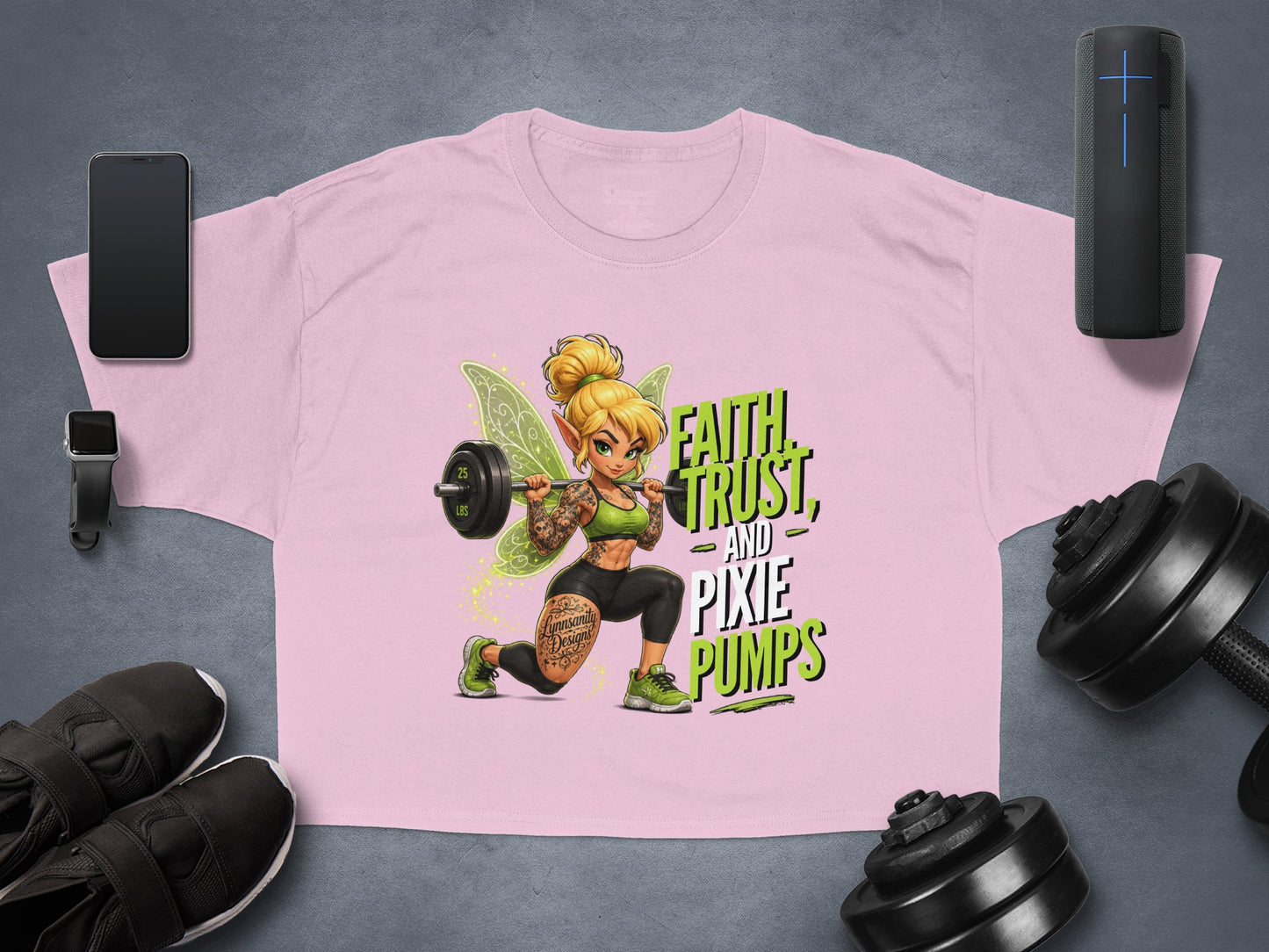 Pink t-shirt with a fairy lifting weights and the text "FAITH, TRUST, AND PIXIE PUMPS".