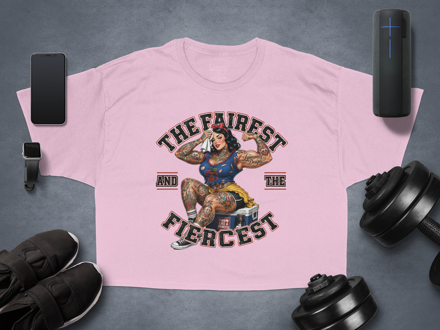 Pink t-shirt with "The Fairest And The Fiercest" graphic featuring a muscular woman.
