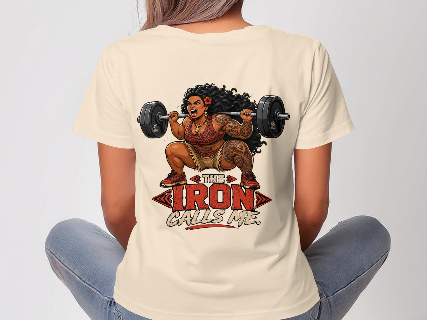Woman in beige t-shirt lifting weights, with text "THE IRON CALLS ME".