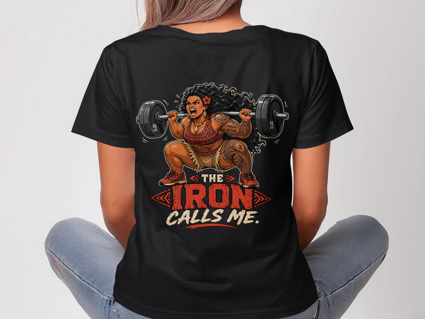 Woman in t-shirt with "The Iron Calls Me" text and barbell graphic.