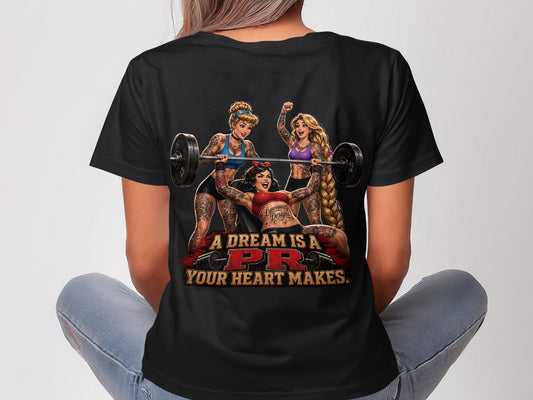 Three tattooed women lift weights with "A DREAM IS A PR YOUR HEART MAKES" text.