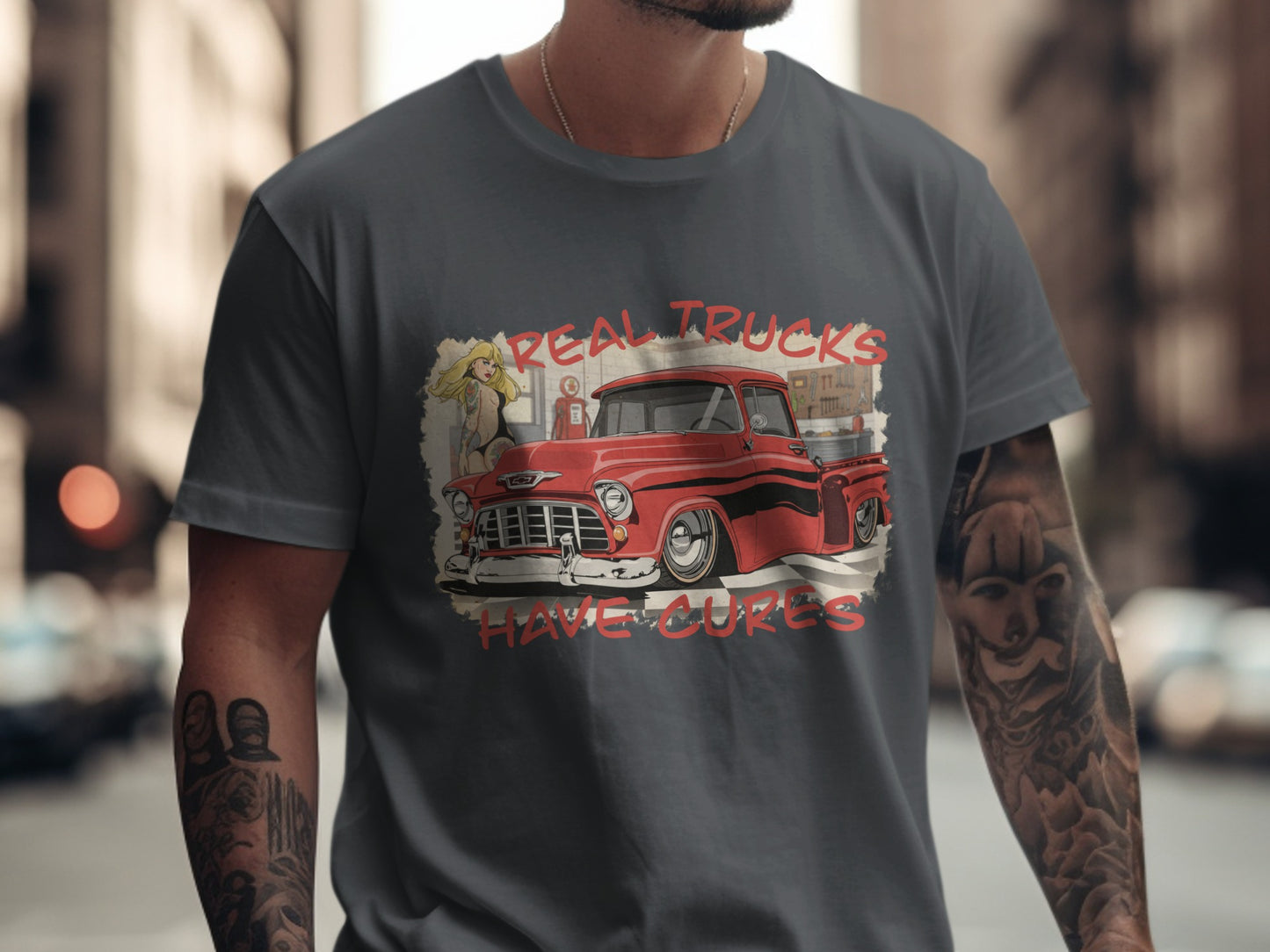 Red vintage truck with "Real Trucks Have Curves" text on a gray t-shirt.