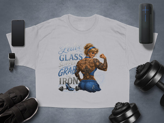 T-shirt with tattooed woman flexing, "Leave the glass slipper, grab the iron" text.