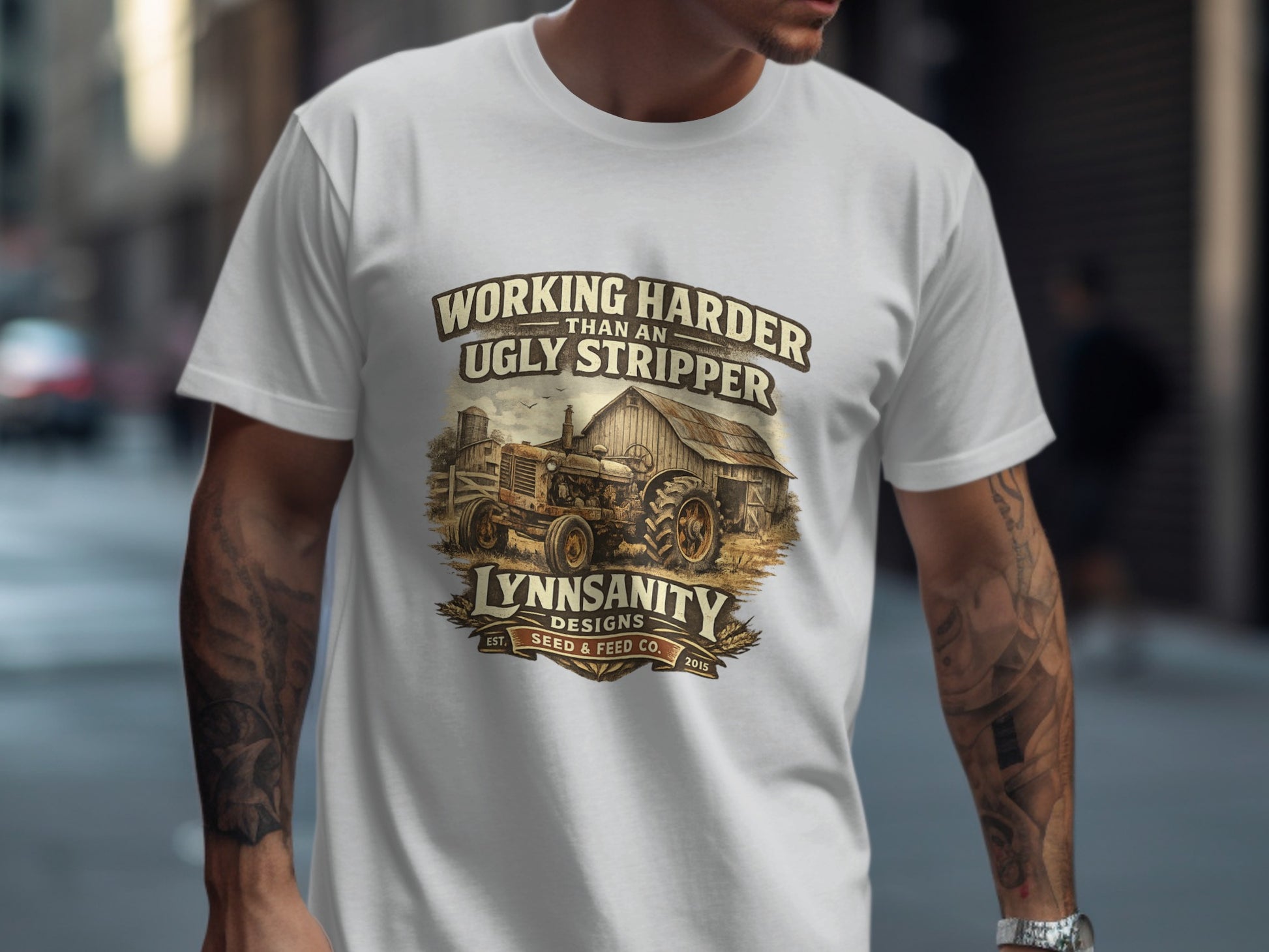 T-shirt graphic with tractor, text "Working Harder Than an Ugly Stripper" and "Lynnsanity Seed & Feed Co.".