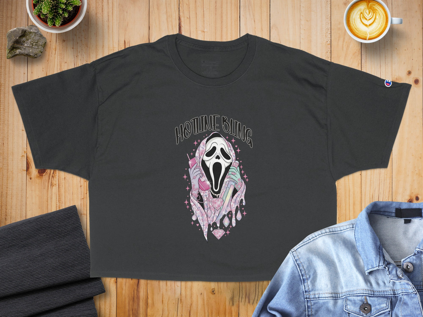 Dark t-shirt with graphic of Ghostface screaming and holding a pink phone.