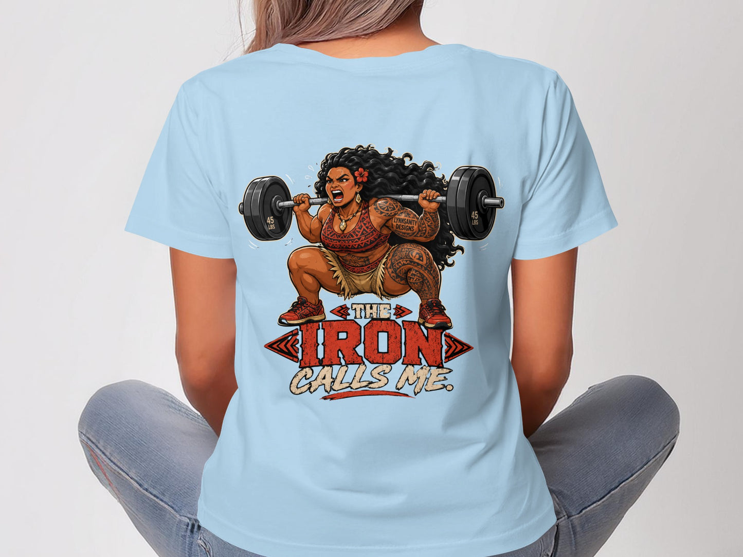 Woman with tattoos, lifting a barbell, with text "The Iron Calls Me."