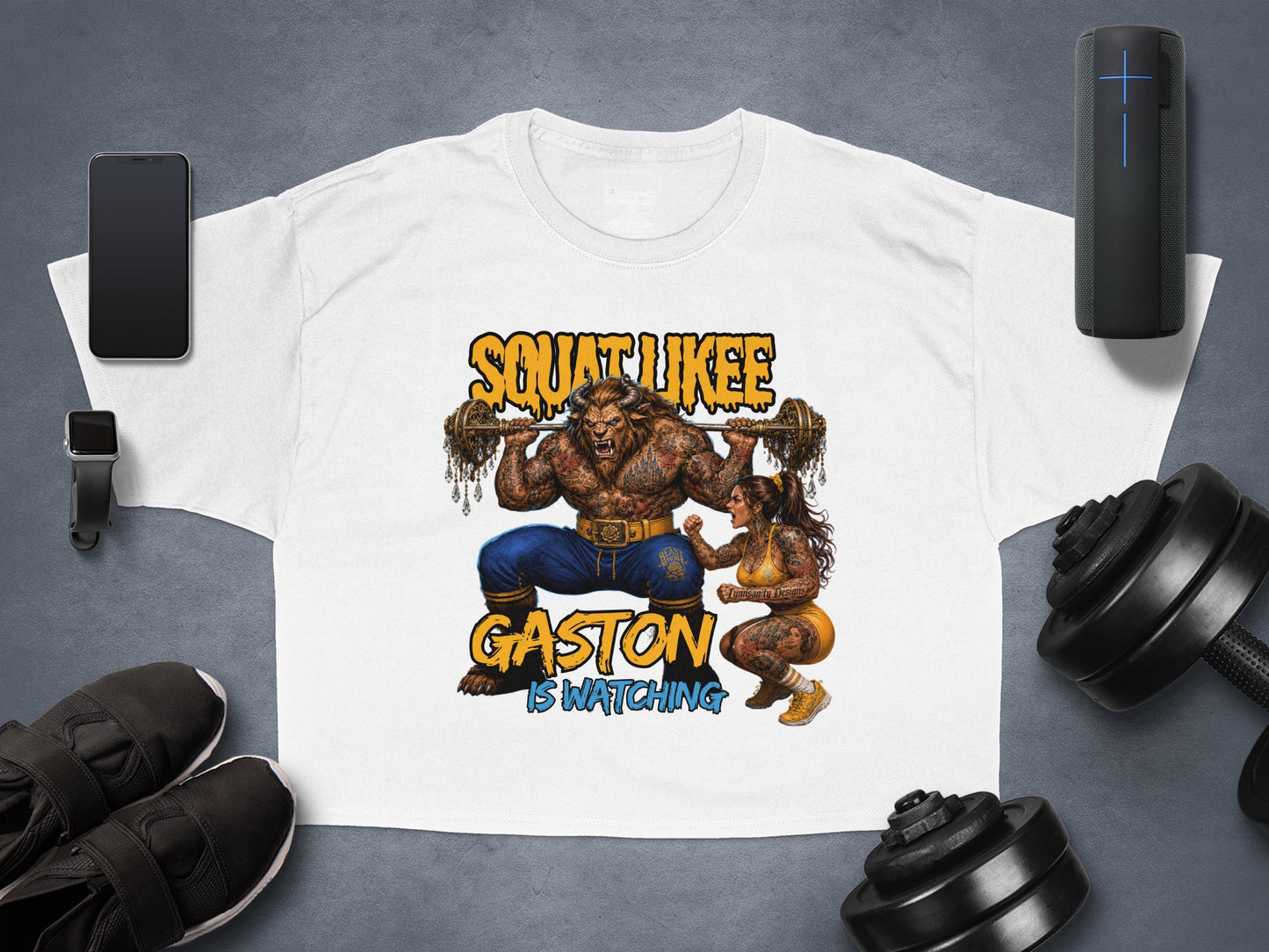 White t-shirt with Gaston lifting weights, text "SQUAT LIKE HE IS WATCHING".