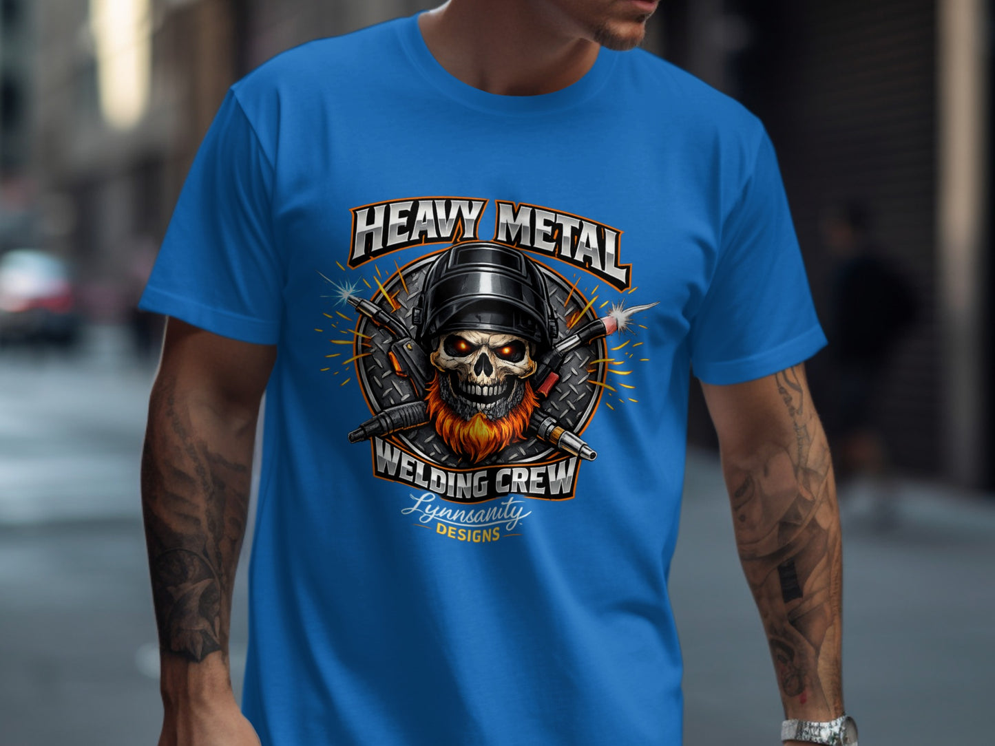 Skull with welding mask and crossed welding torches on a blue t-shirt.
